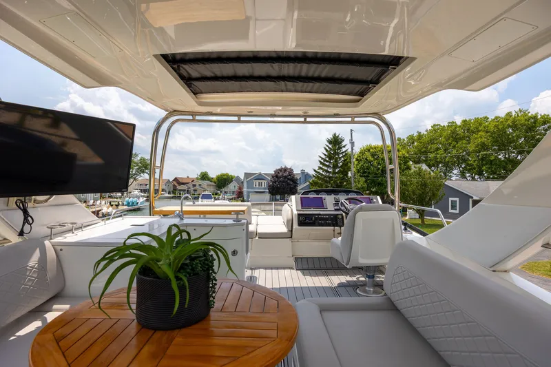 Slide: The Image of Luxurious 2017 Sea Ray Fly 510 yacht interior with helm, seating, and outdoor views. - 13