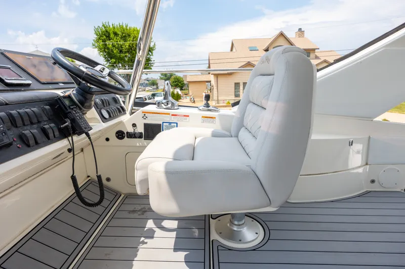 Slide: The Image of Captain's seat and helm of 2017 Sea Ray Fly 510 yacht, featuring modern controls. - 15