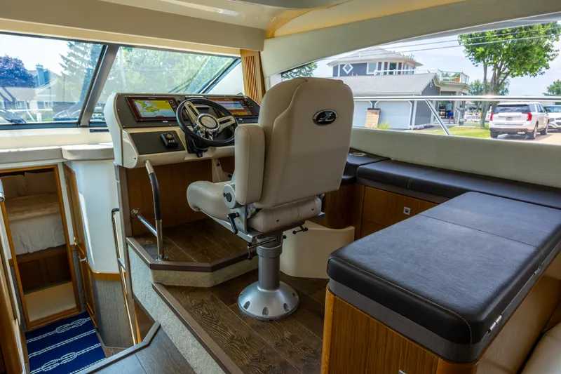 Slide: The Image of Interior helm of 2017 Sea Ray Fly 510 yacht with modern controls and seating. - 30