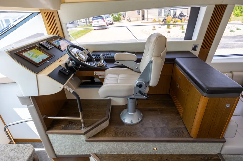 Slide: The Image of Luxurious helm station of 2017 Sea Ray Fly 510 yacht with modern controls and seating. - 31