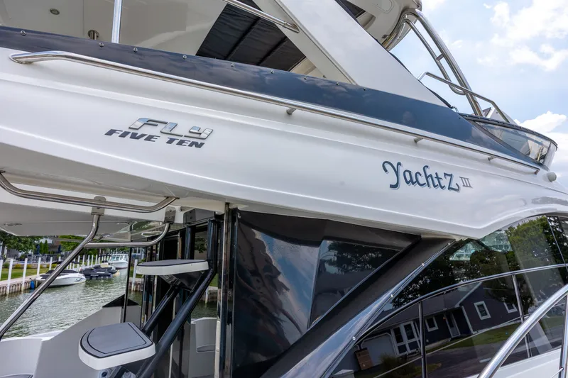 Slide: The Image of 2017 Sea Ray Fly 510 yacht docked, showcasing sleek design and modern features. - 3