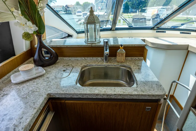 Slide: The Image of Luxurious 2017 Sea Ray Fly 510 yacht kitchen with granite countertop and stainless steel sink. - 34