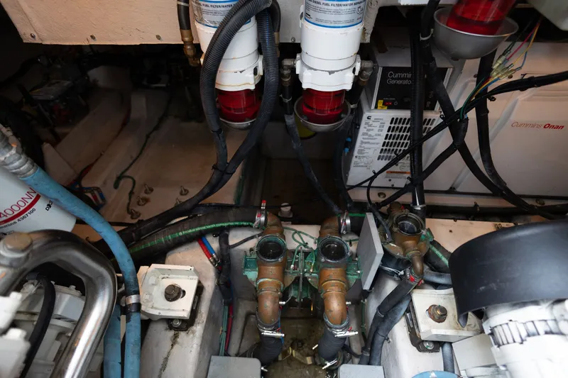 Slide: The Image of Engine room of a 2017 Sea Ray Fly 510 yacht, featuring Cummins Onan generator and fuel filters. - 56