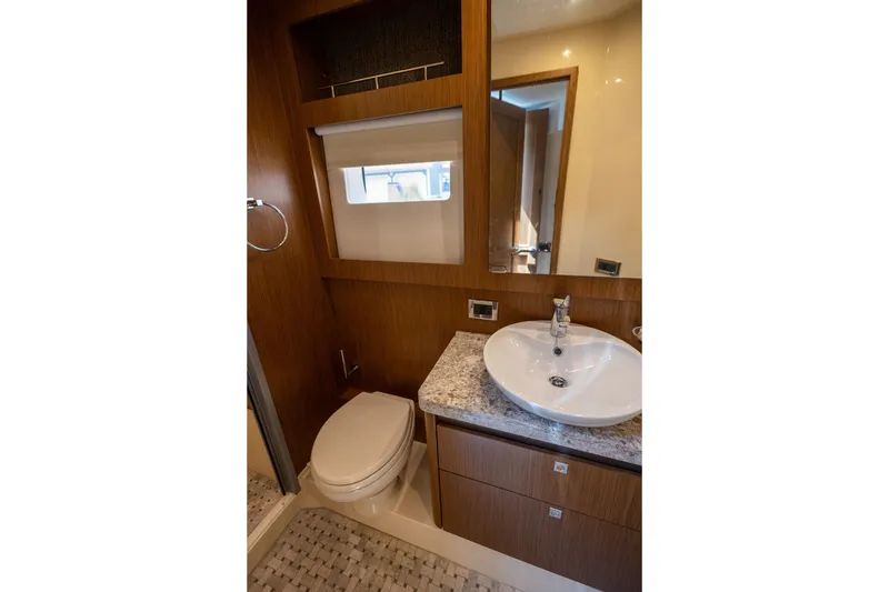 Slide: The Image of Luxurious bathroom in 2017 Sea Ray Fly 510 yacht with modern fixtures and wood accents. - 44
