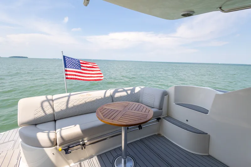 Slide: The Image of Luxurious 2017 Sea Ray Fly 510 yacht deck with American flag and ocean view. - 22