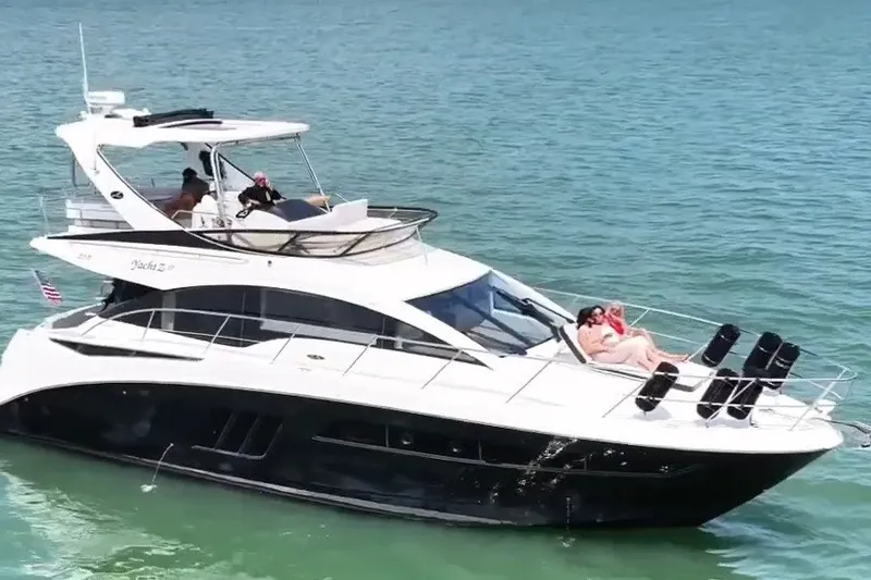 Slide: The Image of 2017 Sea Ray Fly 510 yacht cruising on clear blue water. - 1