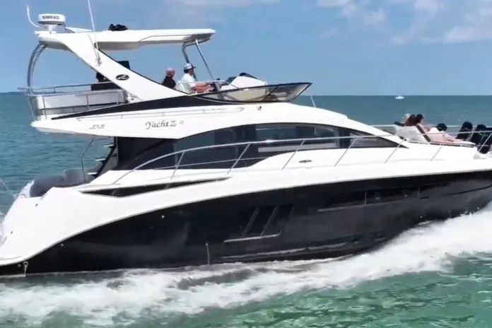 Slide: The Image of 2017 Sea Ray Fly 510 yacht cruising on open water under clear skies. - 57