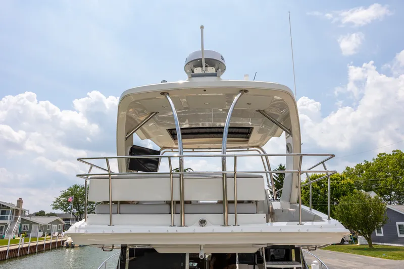 Slide: The Image of 2017 Sea Ray Fly 510 yacht's upper deck with clear sky background. - 9
