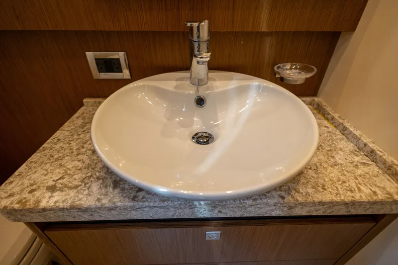 Slide: The Image of Luxurious bathroom sink on 2017 Sea Ray Fly 510 yacht with marble countertop. - 46
