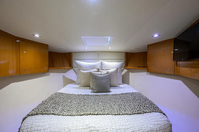 Slide: The Image of Luxurious bedroom interior of 2004 Viking 65 Enclosed Bridge yacht with cozy bedding. - 43