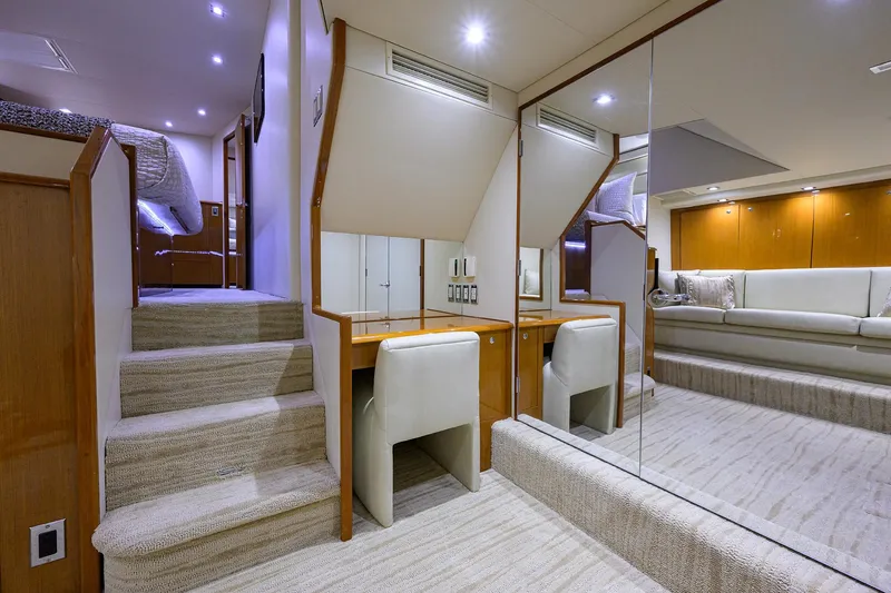 Slide: The Image of Luxurious interior of a 2004 Viking 65 Enclosed Bridge yacht with tower, featuring a cozy seating area. - 27