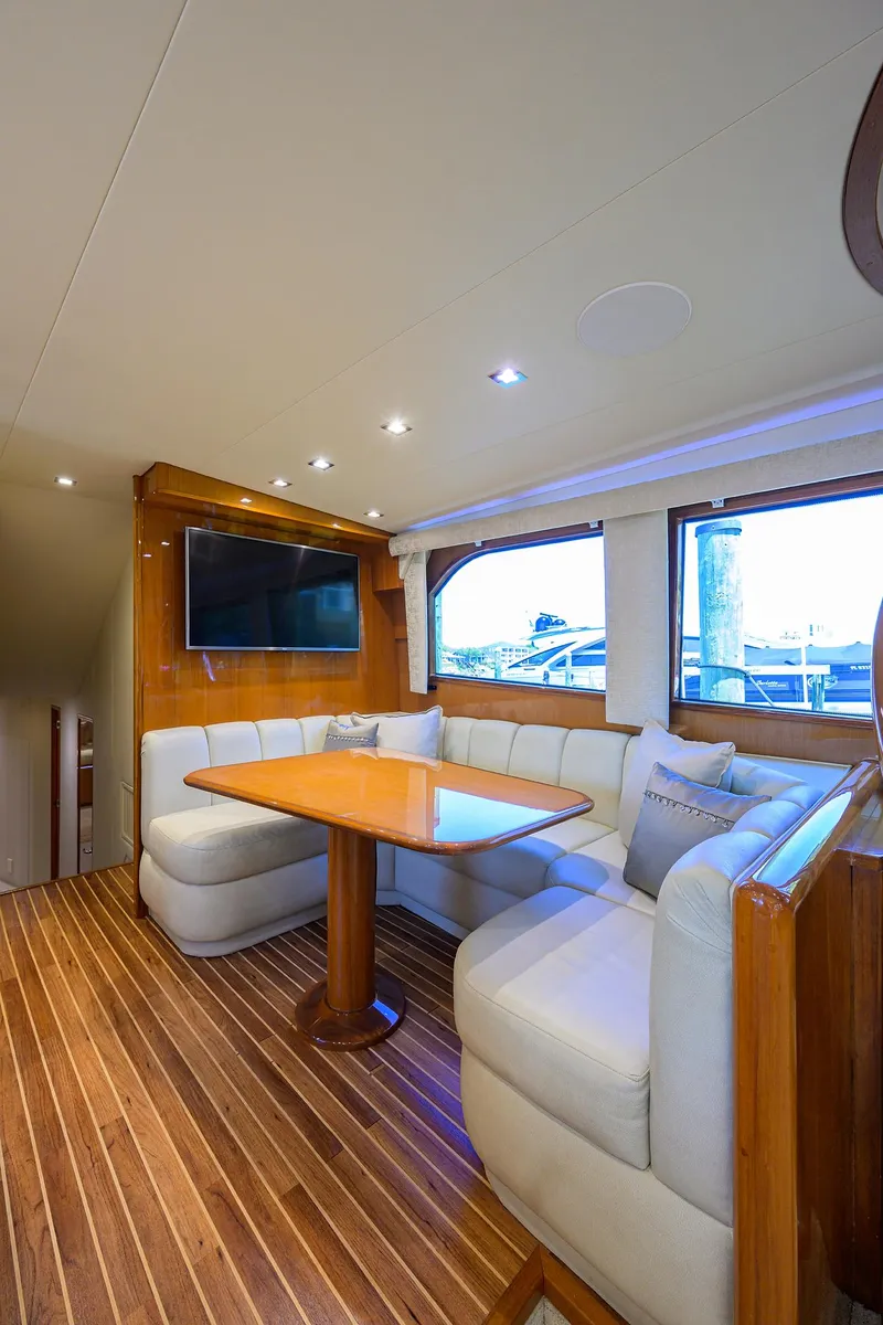 Slide: The Image of Luxurious interior of 2004 Viking 65 Enclosed Bridge yacht with dining area. - 24