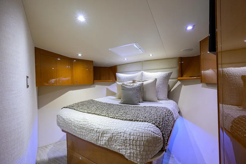 Slide: The Image of Luxurious bedroom interior of 2004 Viking 65 Enclosed Bridge yacht with cozy bed and wooden cabinets. - 42