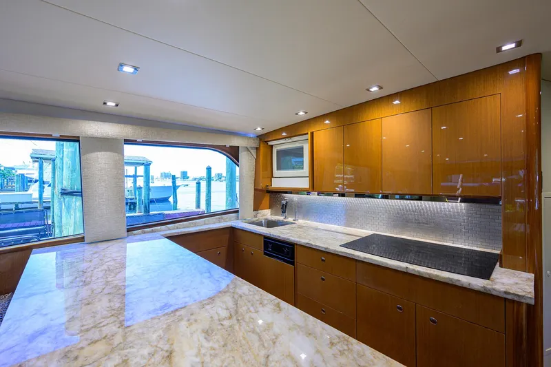 Slide: The Image of Luxurious kitchen interior of 2004 Viking 65 Enclosed Bridge yacht with marble countertops. - 23