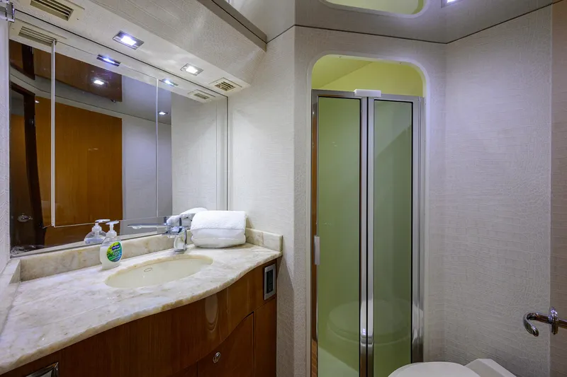 Slide: The Image of Luxurious bathroom on a 2004 Viking 65 Enclosed Bridge yacht with modern fixtures. - 45
