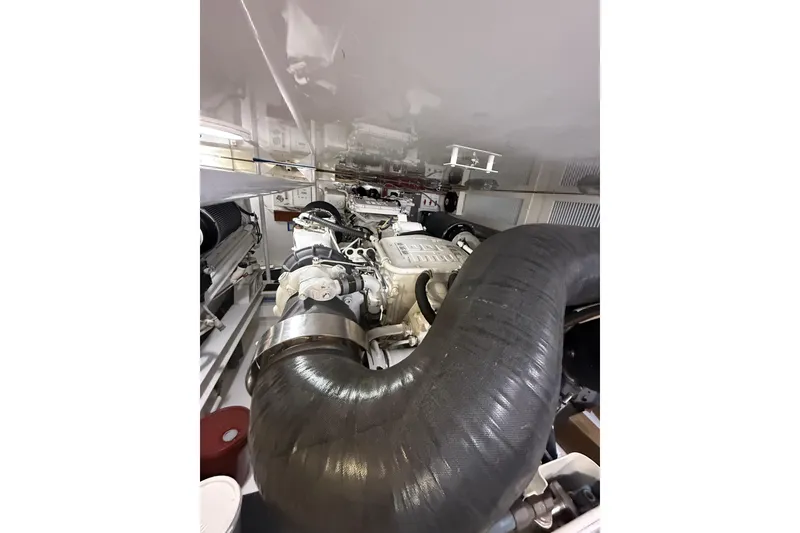 Slide: The Image of Engine room of 2004 Viking 65 Enclosed Bridge yacht, showcasing complex machinery. - 83