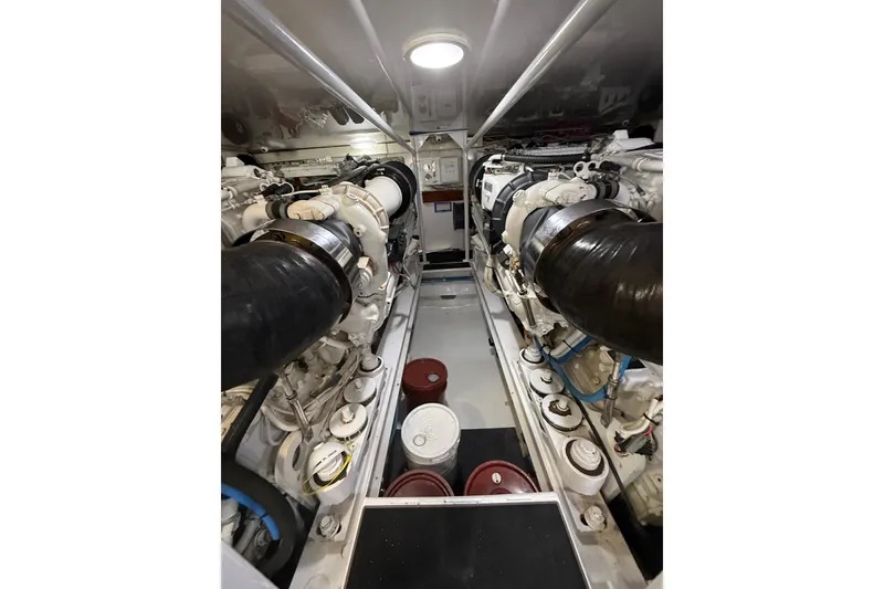 Slide: The Image of Engine room of 2004 Viking 65 Enclosed Bridge yacht, showcasing powerful machinery. - 86