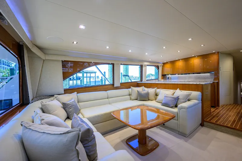 Slide: The Image of Luxurious interior of 2004 Viking 65 Enclosed Bridge yacht with spacious seating and modern kitchen. - 16