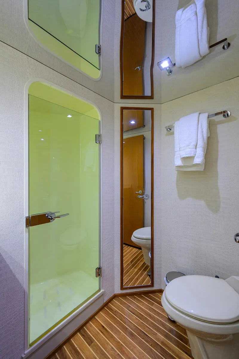 Slide: The Image of 2004 Viking 65 Enclosed Bridge yacht bathroom with shower, toilet, and mirror. - 36