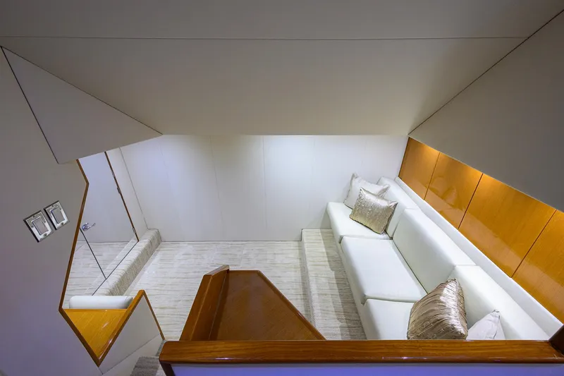 Slide: The Image of Luxurious interior of 2004 Viking 65 Enclosed Bridge yacht with white sofa and wooden accents. - 33