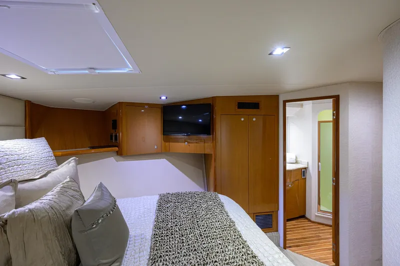 Slide: The Image of Luxurious bedroom interior of 2004 Viking 65 Enclosed Bridge yacht with TV and ensuite bathroom. - 40