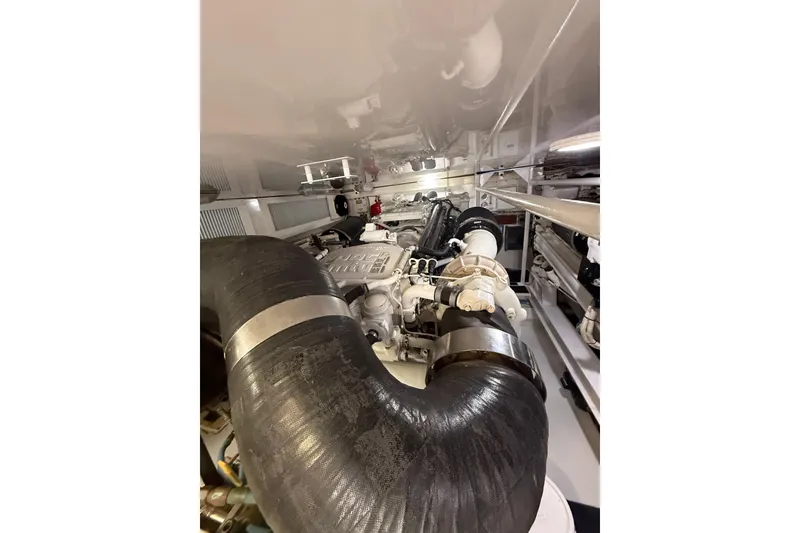 Slide: The Image of Engine room of 2004 Viking 65 Enclosed Bridge yacht, showcasing mechanical components. - 85