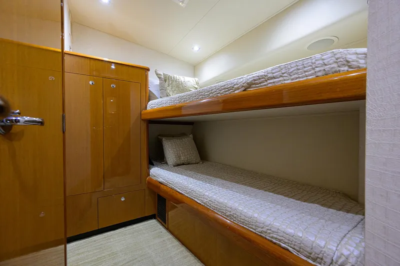 Slide: The Image of 2004 Viking 65 Enclosed Bridge w/Tower cabin with bunk beds and wooden cabinetry. - 51
