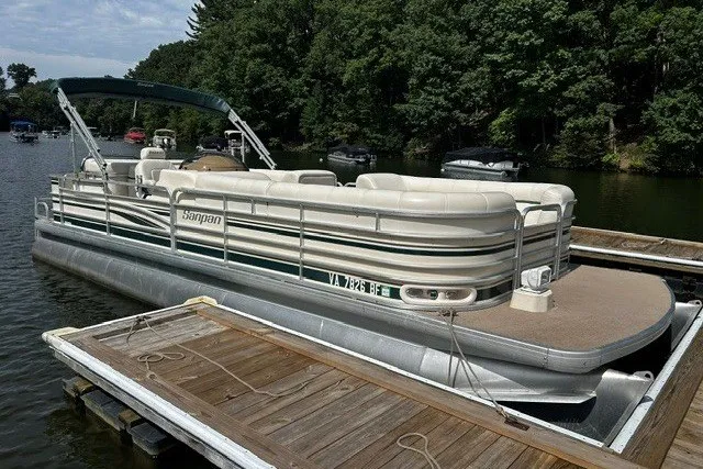 The Image of 2005 Godfrey SANPAN 2500 pontoon boat docked on a serene lake. - 1