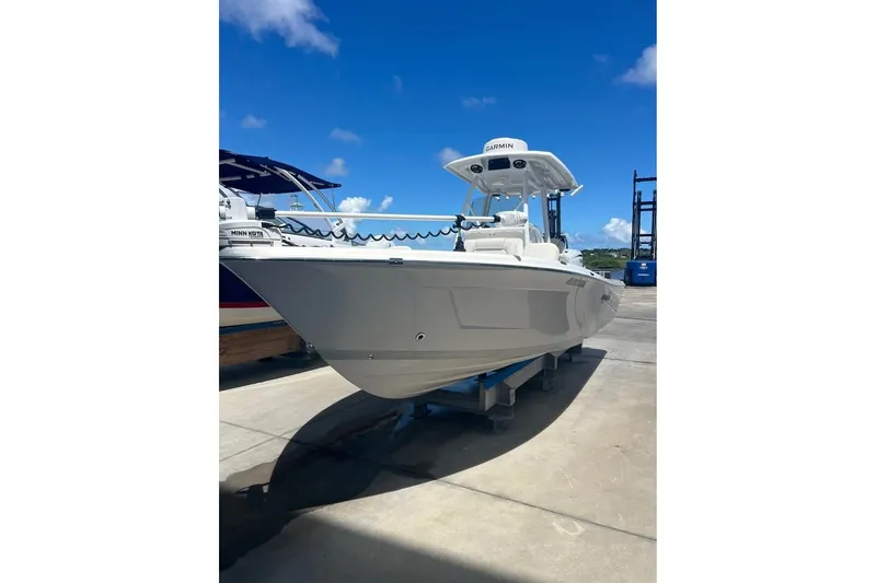 Slide: The Image of 2019 Blue Wave 2800 Pure Hybrid boat on display under clear blue sky. - 2
