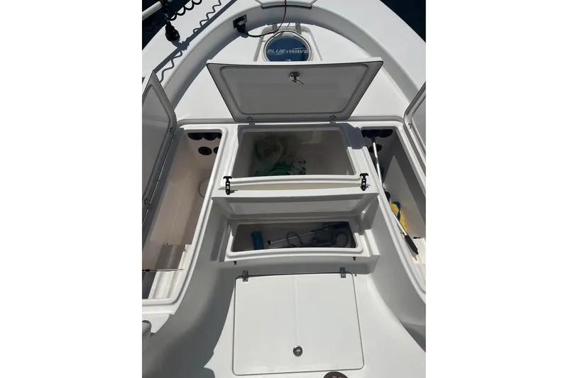 Slide: The Image of 2019 Blue Wave 2800 Pure Hybrid boat storage compartments open on deck. - 9