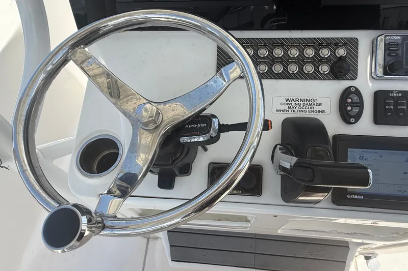 Slide: The Image of Steering wheel and controls of a 2019 Blue Wave 2800 Pure Hybrid boat. - 39