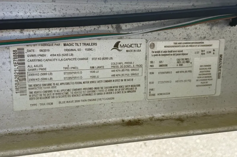 Slide: The Image of Label on Magic Tilt trailer, detailing specifications and tire information for Blue Wave 2800 Pure Hybrid. - 72