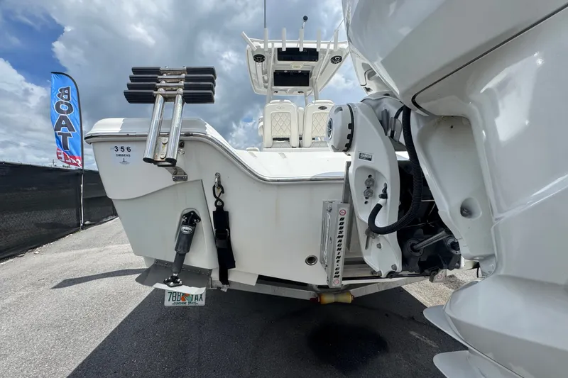 Slide: The Image of 2019 Blue Wave 2800 Pure Hybrid boat rear view with motor and ladder. - 26