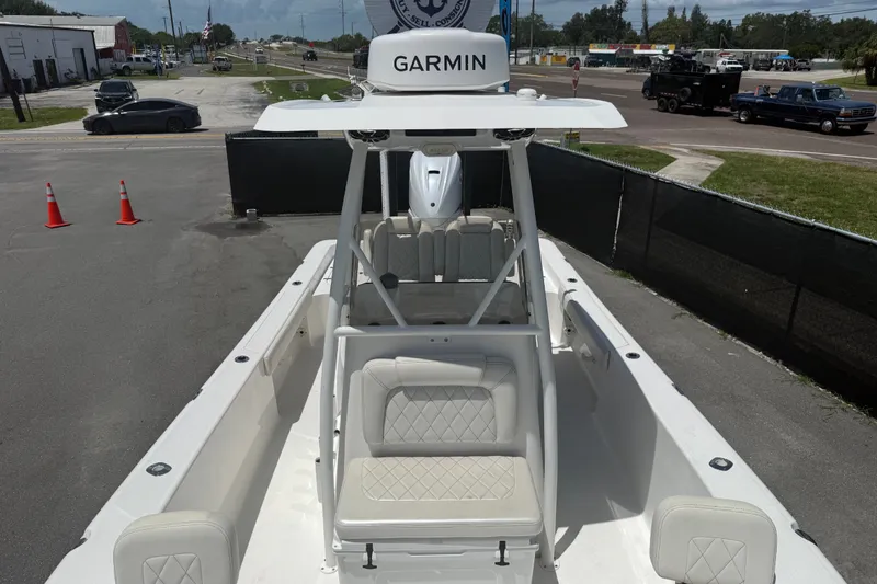 Slide: The Image of 2019 Blue Wave 2800 Pure Hybrid boat with Garmin equipment, parked outdoors. - 55