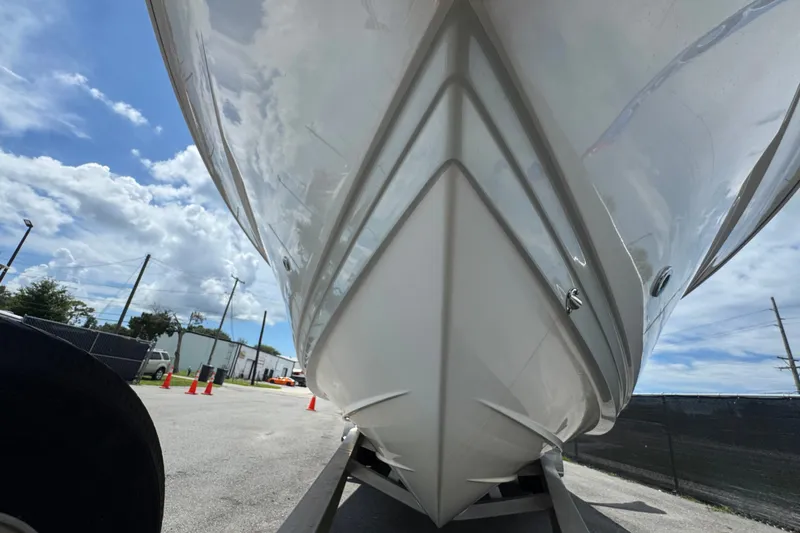 Slide: The Image of 2019 Blue Wave 2800 Pure Hybrid boat hull on trailer under blue sky. - 9