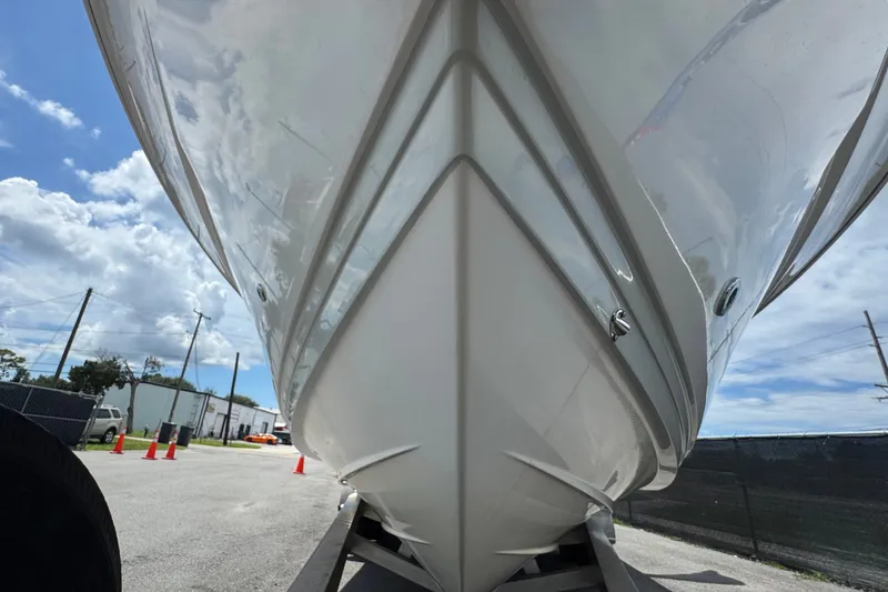 Slide: The Image of 2019 Blue Wave 2800 Pure Hybrid boat hull on trailer under blue sky. - 15