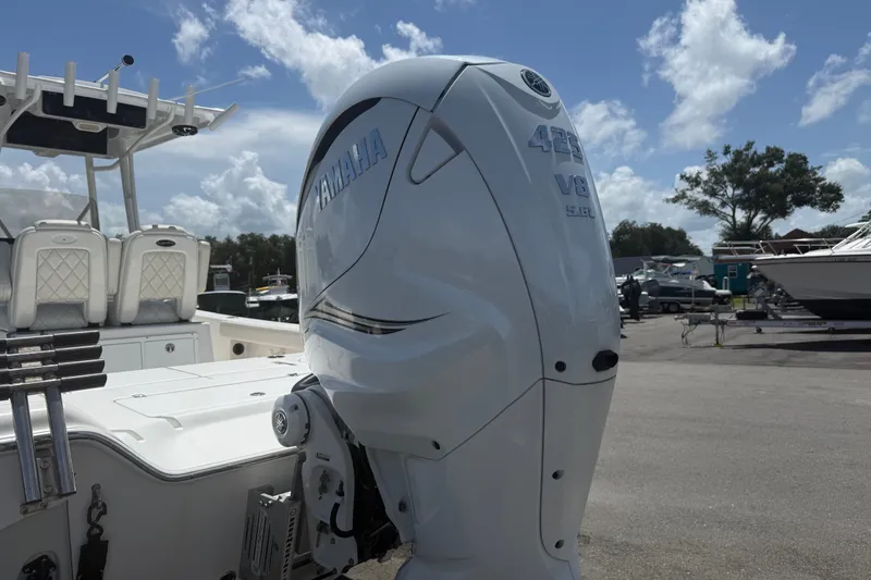 Slide: The Image of 2019 Blue Wave 2800 Pure Hybrid boat with Yamaha 425 V8 engine, parked outdoors. - 21