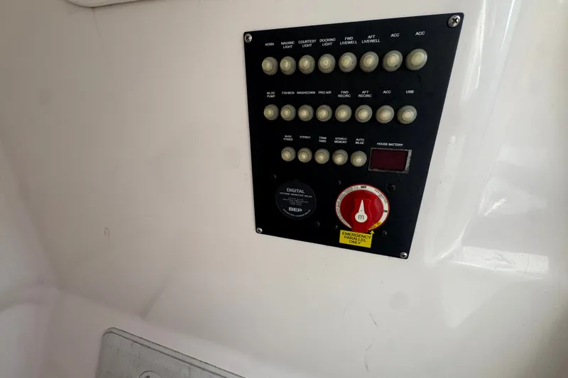 Slide: The Image of Control panel of a 2019 Blue Wave 2800 Pure Hybrid boat with labeled switches. - 75