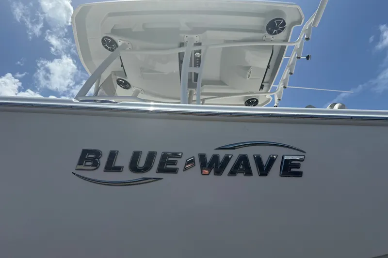 Slide: The Image of 2019 Blue Wave 2800 Pure Hybrid boat under a clear blue sky. - 1