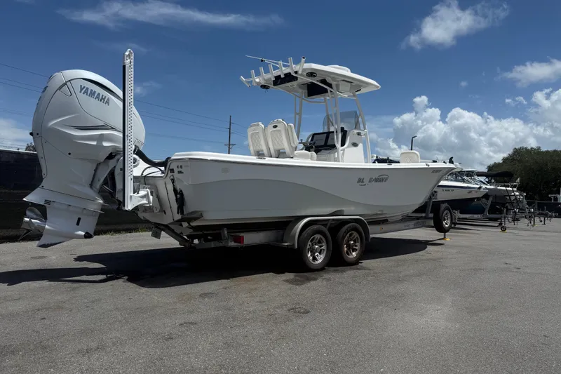 Slide: The Image of 2019 Blue Wave 2800 Pure Hybrid boat with Yamaha engine on trailer under blue sky. - 14