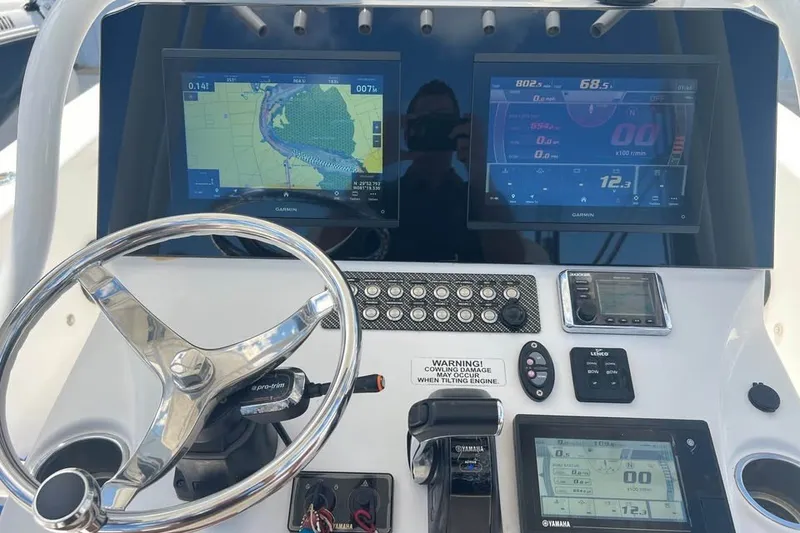 Slide: The Image of Dashboard of a 2019 Blue Wave 2800 Pure Hybrid boat with navigation screens. - 5