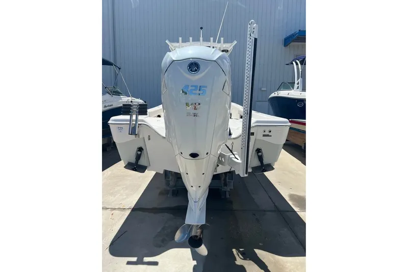 Slide: The Image of 2019 Blue Wave 2800 Pure Hybrid boat with powerful outboard motor in a marina setting. - 3