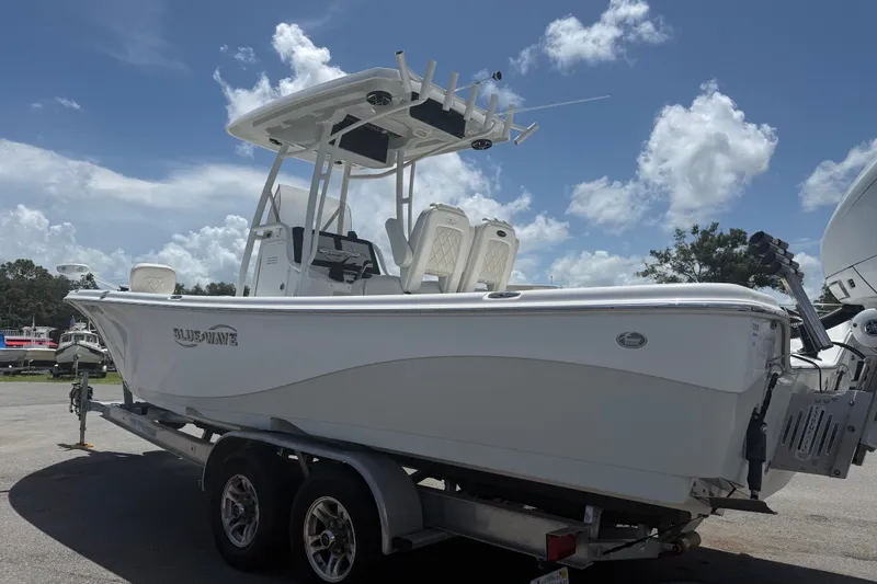 Slide: The Image of 2019 Blue Wave 2800 Pure Hybrid boat on trailer under blue sky. - 4