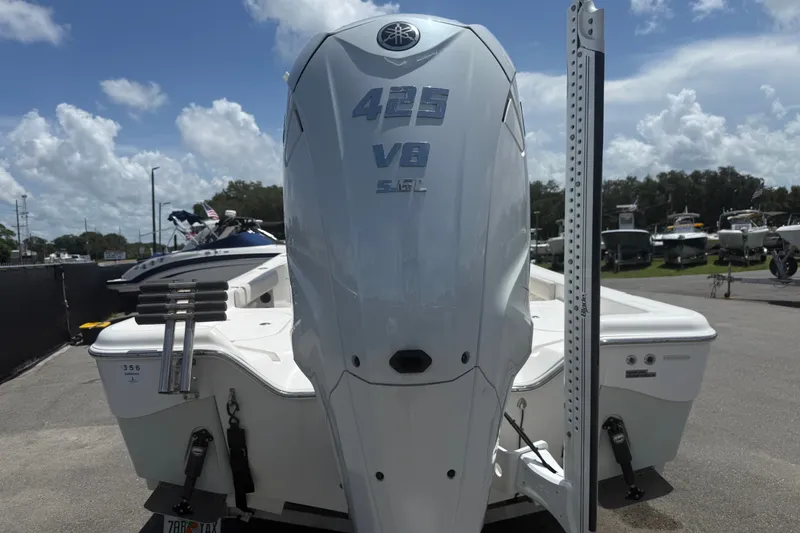 Slide: The Image of 2019 Blue Wave 2800 Pure Hybrid boat with powerful 425 V8 engine displayed outdoors. - 18