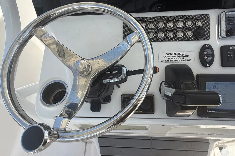 Slide: The Image of Steering wheel and controls of a 2019 Blue Wave 2800 Pure Hybrid boat. - 20