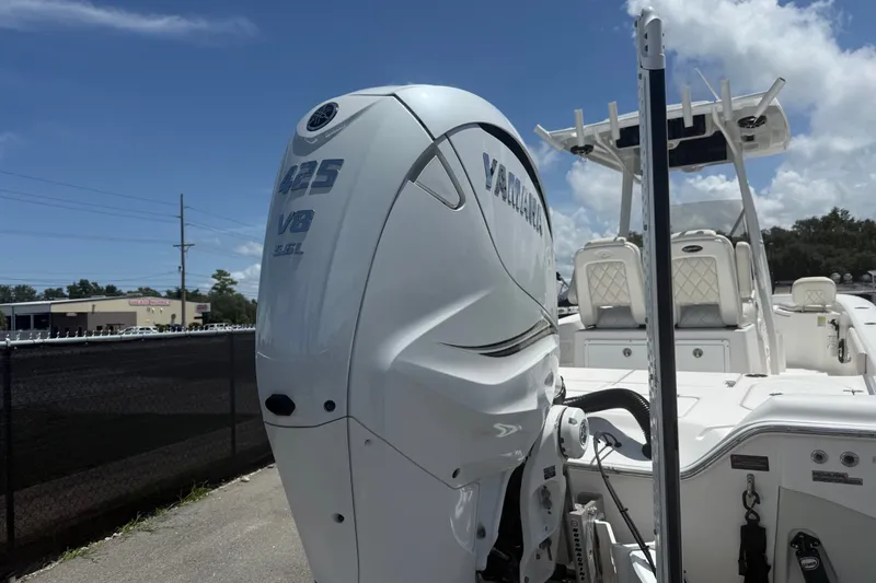 Slide: The Image of 2019 Blue Wave 2800 Pure Hybrid boat with Yamaha 425 V8 engine, parked outdoors. - 20