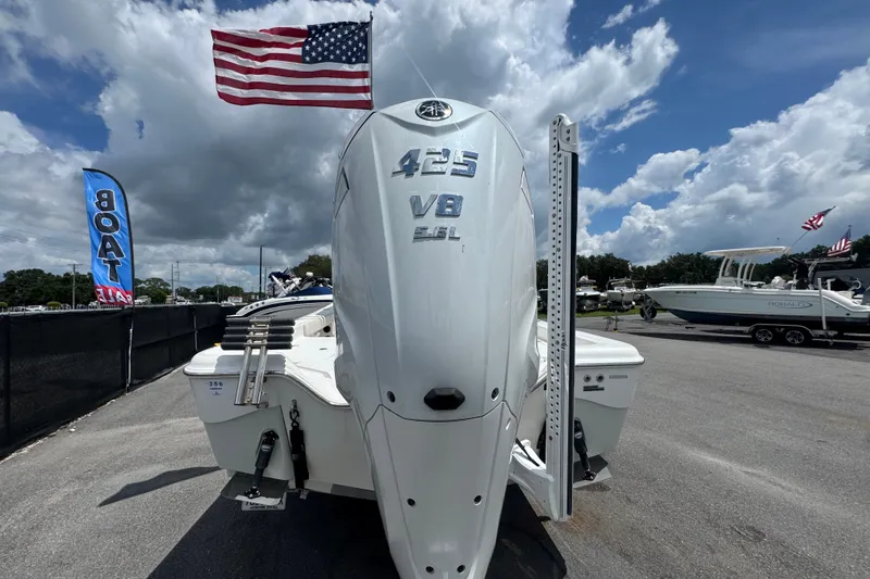 Slide: The Image of 2019 Blue Wave 2800 Pure Hybrid boat with 425 V8 engine, American flag, and sale banner. - 17