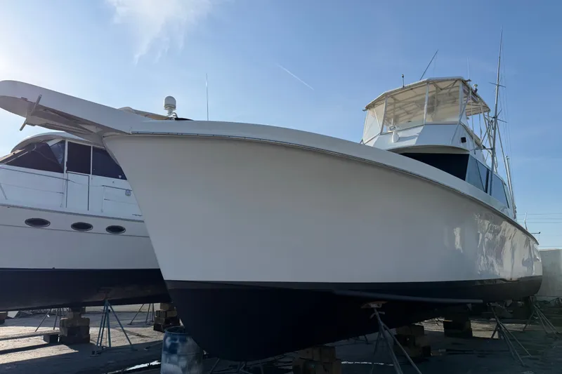 Slide: The Image of 1967 Hatteras 41 Convertible yacht on dry dock under clear blue sky. - 17