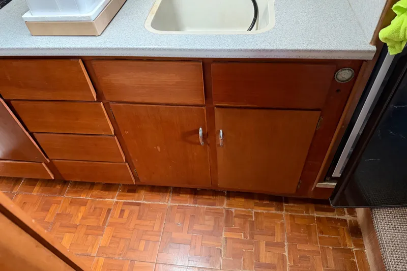 Slide: The Image of Wooden cabinetry and sink in 1967 Hatteras 41 Convertible boat interior. - 13