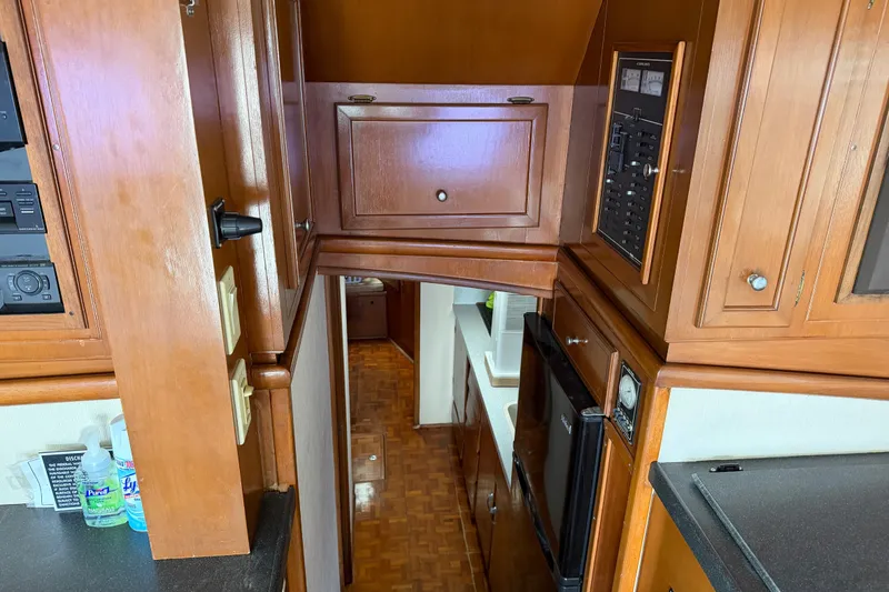 Slide: The Image of Interior of 1967 Hatteras 41 Convertible yacht with wooden cabinetry and modern appliances. - 5